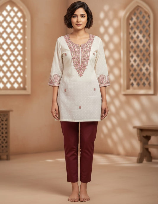 Off white dobby cotton with multi-colored embroidery in M